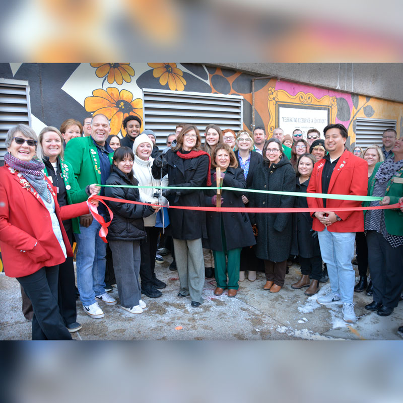 Phit Theta Kappa students work with artist Cherie Lee on a community mural project